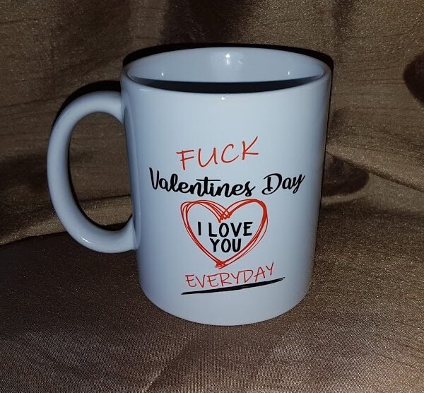 "White 15 oz. ceramic mug with the bold text 'F*ck Valentine's Day, I Love You Every Day' sublimated in vibrant colors, showcasing a quirky and heartfelt design. Perfect for daily use, dishwasher and microwave safe."