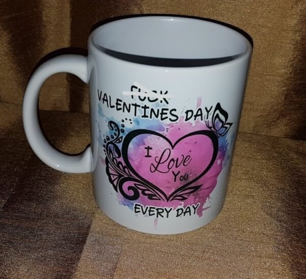 "White 15 oz. ceramic mug with the bold text 'F*ck Valentine's Day, I Love You Every Day' sublimated in vibrant colors, showcasing a quirky and heartfelt design. Perfect for daily use, dishwasher and microwave safe."